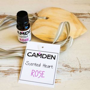 Scented heart and oil on wooden table